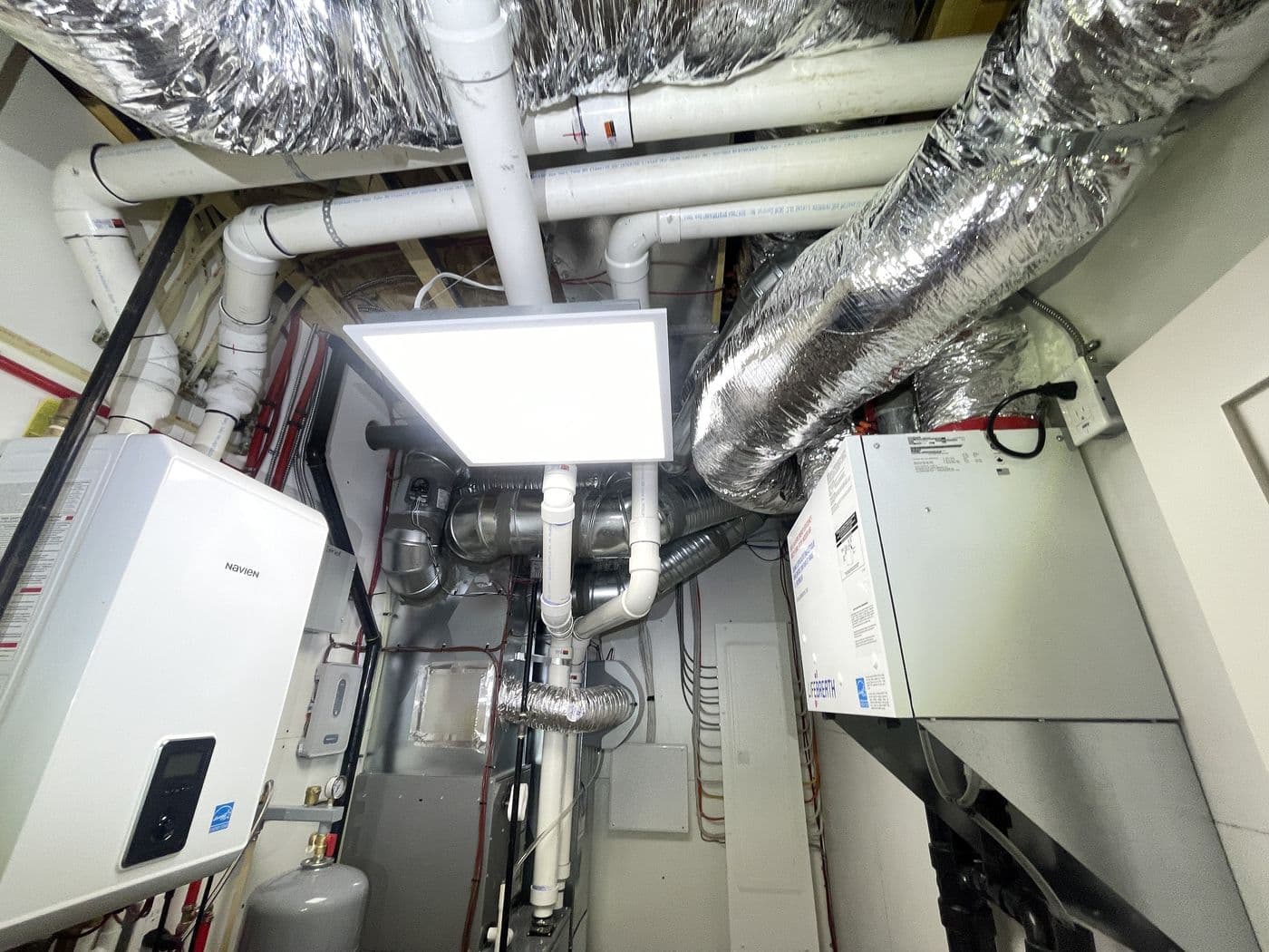 Furnace, water heater and ductwork in a new home's mechanical room