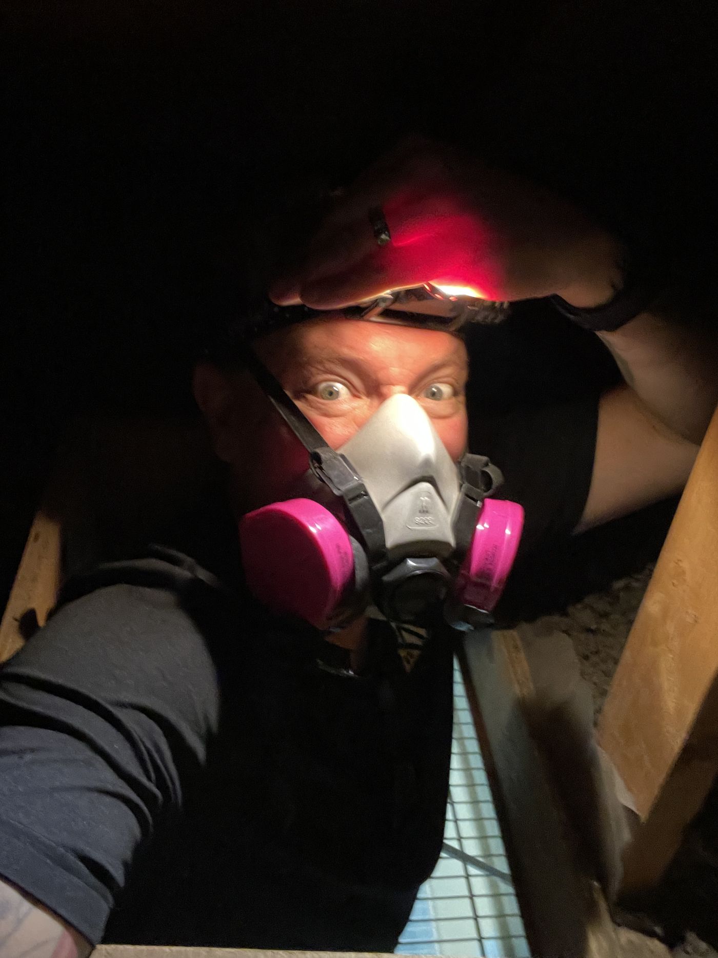 Kyle Dowdeswell inspecting a tight space in a respirator